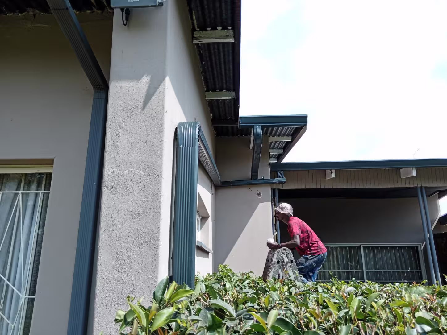 Newly installed aluminium gutters on residential home running clear after rainfall — Centurion