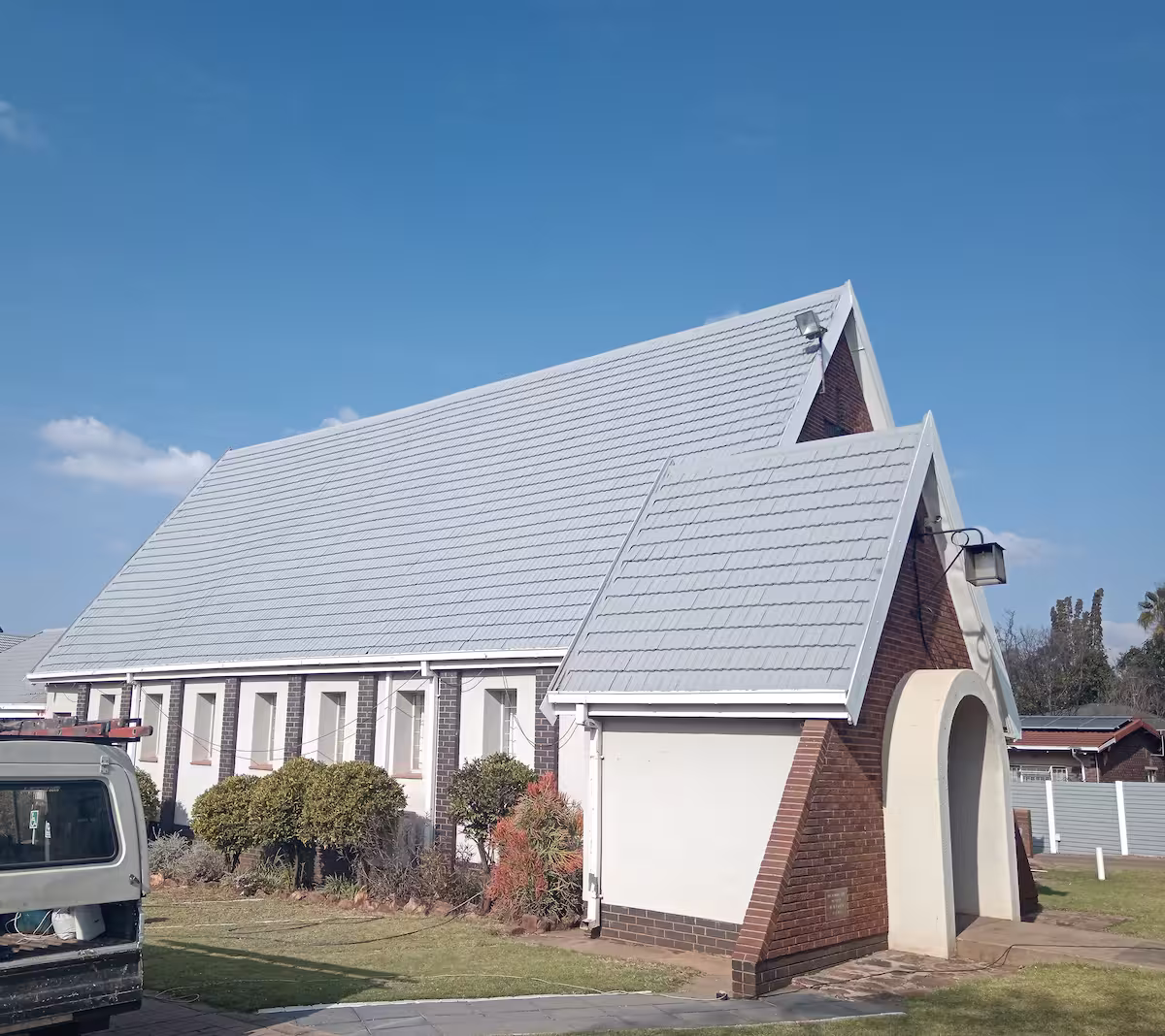 Residential home with freshly painted roof showing vibrant colour restoration — Centurion Gauteng